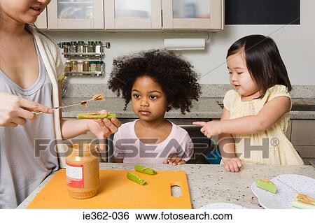 A mother making food for children View Large Photo Image Stock Photograph - A mother making food for children. Fotosearch