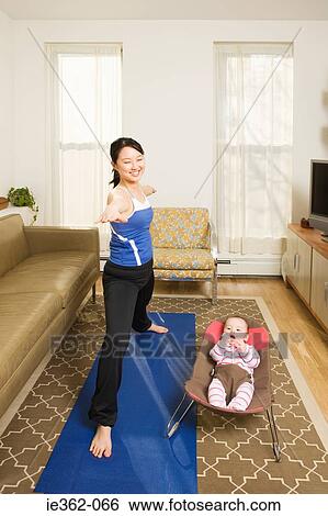 A mother practising yoga View Large Photo Image Stock Photograph - A mother practising yoga. Fotosearch