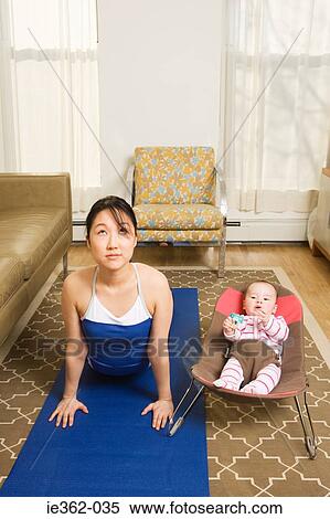 A mother practising yoga View Large Photo Image Stock Photography - A mother practising yoga. Fotosearch