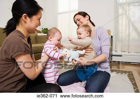Stock Image - Mothers and their babies playing. Fotosearch