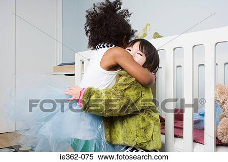 Stock Photography - Two girls hugging. Fotosearch