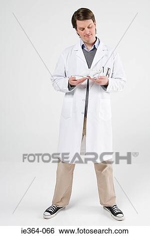 Scientist holding rat View Large Photo Image Stock Photograph - Scientist holding rat. Fotosearch