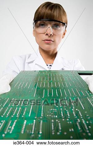 Picture - Scientist with circuit board. Fotosearch