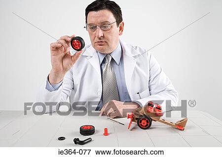 Stock Photo - Scientist with model helicopter. Fotosearch