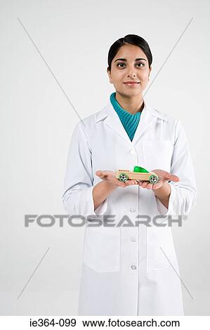 Scientist with toy car View Large Photo Image Stock Photo - Scientist with toy car. Fotosearch