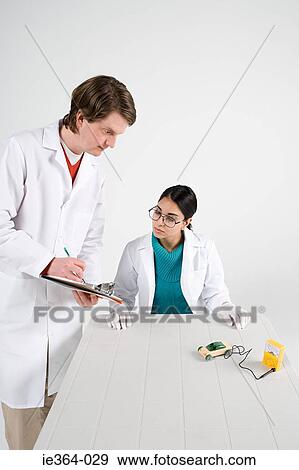 Scientists with model car View Large Photo Image Stock Photo - Scientists with model car. Fotosearch