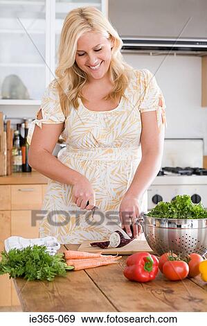 A woman chopping an aubergine View Large Photo Image Stock Photo - A woman chopping an aubergine. Fotosearch