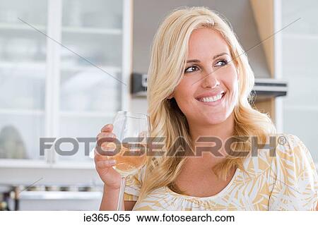 A woman having a glass of wine View Large Photo Image Stock Photography - A woman having a glass of wine. Fotosearch