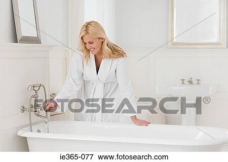 Stock Photo - A woman running a bath. Fotosearch