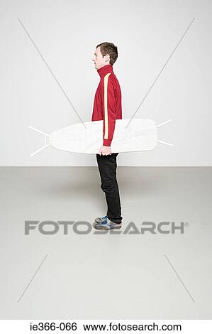 Man holding ironing board like surfboard View Large Photo Image Stock Photograph - Man holding ironing board like surfboard. Fotosearch