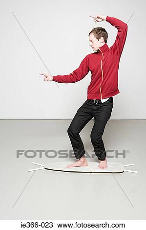 Man surfing on an ironing board View Large Photo Image Stock Image - Man surfing on an ironing board. Fotosearch
