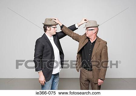 Men holding hats View Large Photo Image Stock Photography - Men holding hats. Fotosearch