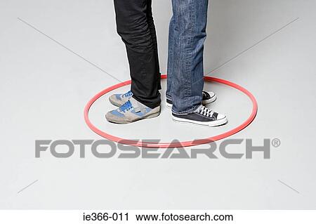 Men standing in plastic hoop View Large Photo Image Stock Image - Men standing in plastic hoop. Fotosearch