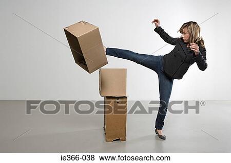 Woman kicking cardboard boxes View Large Photo Image Stock Photo - Woman kicking cardboard boxes. Fotosearch