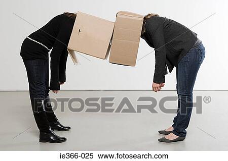 Stock Photography - Women with boxes on their heads. Fotosearch