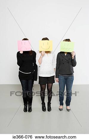 Stock Photograph - Women with drawn faces. Fotosearch