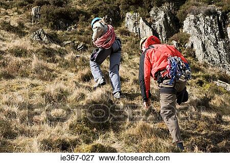 A couple climbing a mountain View Large Photo Image Stock Photo - A couple climbing a mountain. Fotosearch