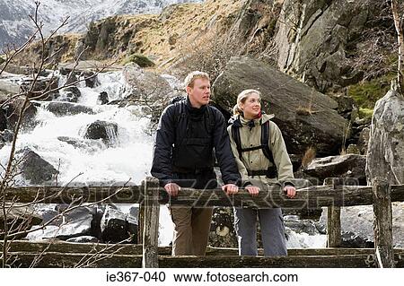 A couple on a bridge View Large Photo Image Stock Image - A couple on a bridge. Fotosearch