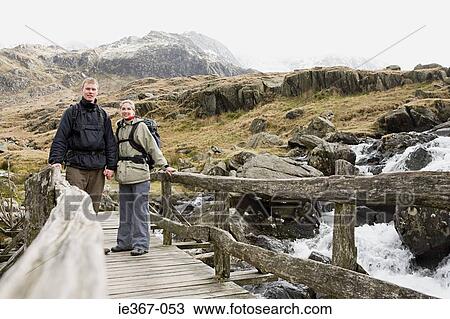 A couple on a bridge View Large Photo Image Stock Image - A couple on a bridge. Fotosearch