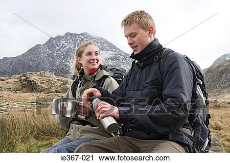 Stock Image - Hikers taking a break. Fotosearch