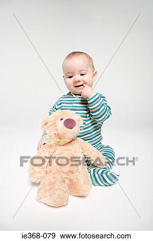 Stock Photo - A baby boy and a teddy. Fotosearch
