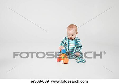 A baby boy playing with a toy View Large Photo Image Stock Photo - A baby boy playing with a toy. Fotosearch