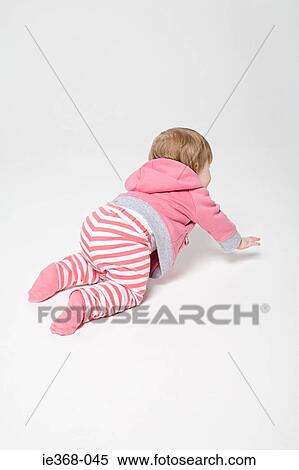 A baby girl crawling View Large Photo Image Stock Photography - A baby girl crawling. Fotosearch