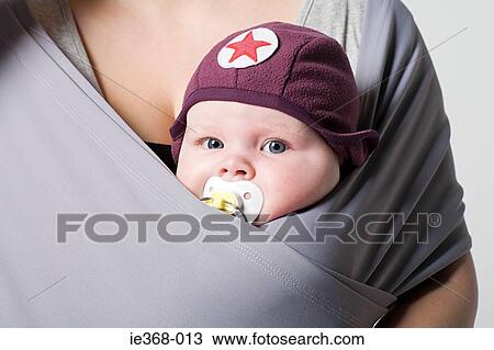 Stock Image - A baby in a baby sling. Fotosearch