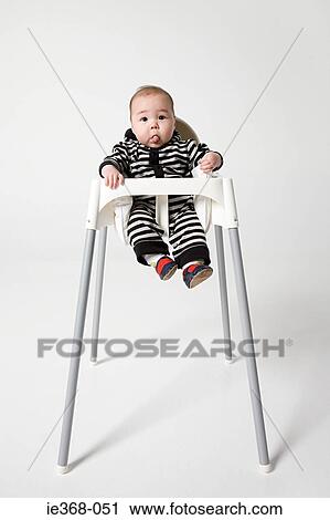 A baby in a high chair View Large Photo Image Stock Image - A baby in a high chair. Fotosearch