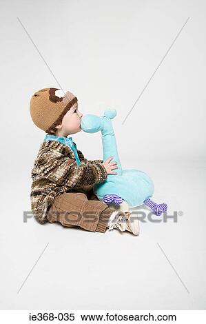 A boy and a soft toy View Large Photo Image Stock Photography - A boy and a soft toy. Fotosearch