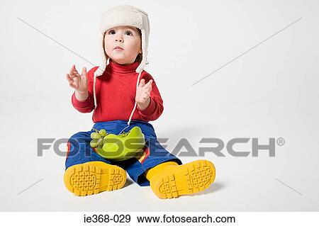Stock Photo - A boy holding a bowl of grapes. Fotosearch