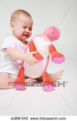 A boy holding a soft toy View Large Photo Image Stock Image - A boy holding a soft toy. Fotosearch