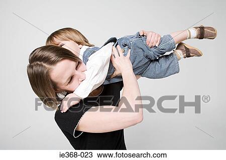 A mother lifting her son View Large Photo Image Stock Image - A mother lifting her son. Fotosearch