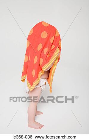 A towel covering a boys head View Large Photo Image Stock Photograph - A towel covering a boys head. Fotosearch