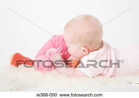 Baby girl holding a toy View Large Photo Image Stock Image - Baby girl holding a toy. Fotosearch
