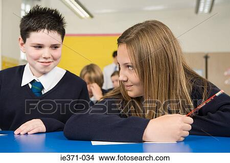 Picture - Boy and girl in class. Fotosearch