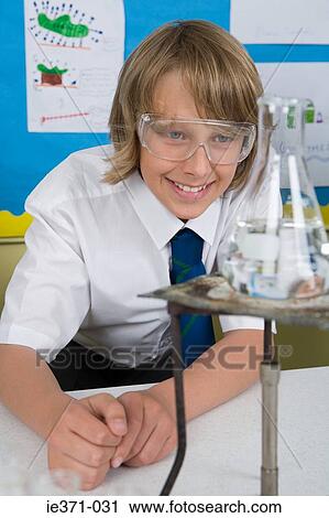 Boy in chemistry lesson View Large Photo Image Stock Image - Boy in chemistry lesson. Fotosearch
