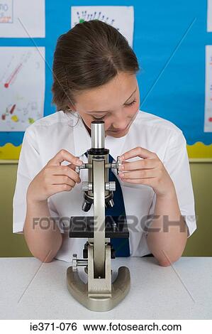 Girl looking in microscope View Large Photo Image Stock Photograph - Girl looking in microscope. Fotosearch