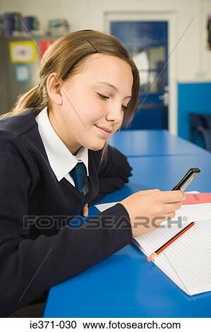 Girl with cellphone in classroom View Large Photo Image Stock Image - Girl with cellphone in classroom. Fotosearch