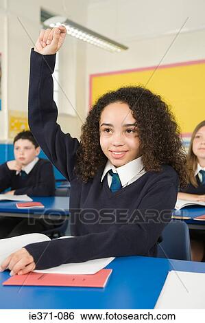 Stock Photograph - Girl with hand raised. Fotosearch
