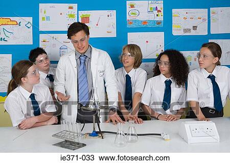 Stock Image - Science teacher and pupils. Fotosearch