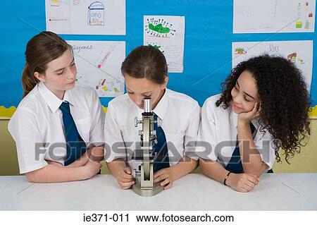 Students with microscope View Large Photo Image Stock Image - Students with microscope. Fotosearch