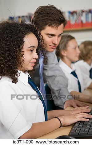Teacher and girl with computer View Large Photo Image Stock Image - Teacher and girl with computer. Fotosearch