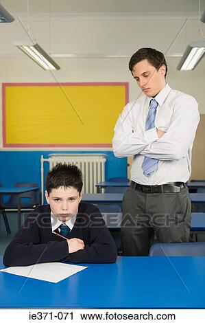 Stock Image - Teacher annoyed at pupil. Fotosearch