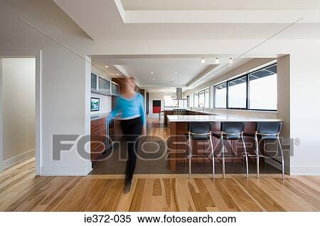 Woman walking through kitchen View Large Photo Image Stock Photography - Woman walking through kitchen. Fotosearch