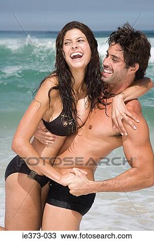 Hispanic couple playing in the sea View Large Photo Image Stock Image - Hispanic couple playing in the sea. Fotosearch