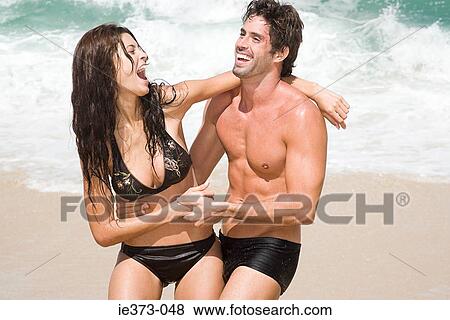 Hispanic couple playing on a beach View Large Photo Image Stock Photo - Hispanic couple playing on a beach. Fotosearch
