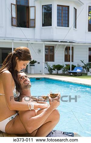 Hispanic couple relaxing by the pool View Large Photo Image Stock Image - Hispanic couple relaxing by the pool. Fotosearch