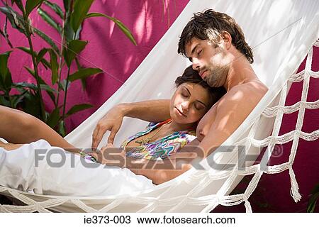 Hispanic couple sleeping in a hammock View Large Photo Image Stock Image - Hispanic couple sleeping in a hammock. Fotosearch