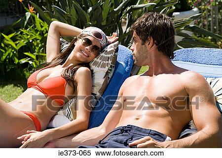 Hispanic couple sunbathing View Large Photo Image Stock Photography - Hispanic couple sunbathing. Fotosearch